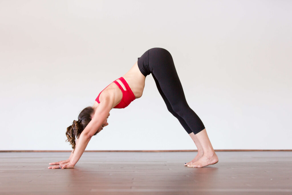 Kristin doing the Downward-Facing Dog pose