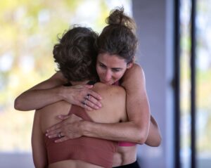 yoga for pain relief, Lara hugging a student