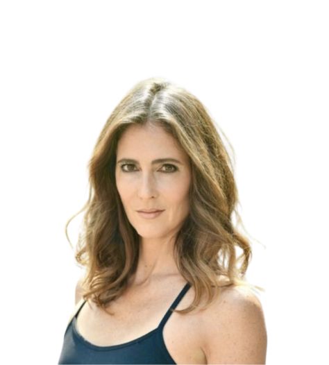 Portrait of a woman with wavy brown hair wearing a navy camisole against a white background.